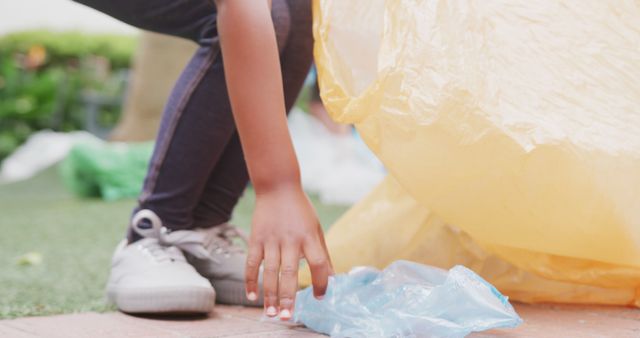 Person Picking Up Plastic Trash in an Outdoor Setting - Download Free Stock Images Pikwizard.com