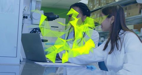 Female researchers collaborating at microscope with neon data visualization overlay