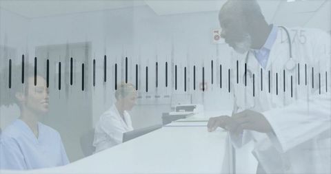 Doctor leaning at reception desk speaking with front desk staff in modern medical clinic
