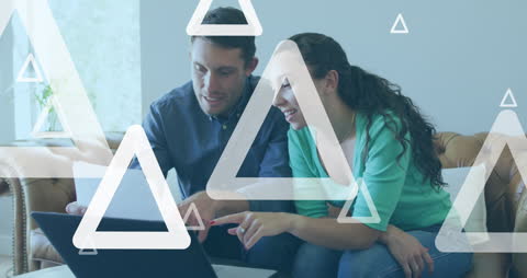 Couple Collaborating on Laptop with Digital Graphics Overlay