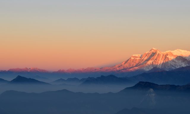 Sunset Over Mountain Peaks with Glowing Snow-capped Summit in Distance - Download Free Stock Photos Pikwizard.com