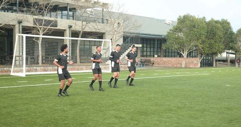 Team of soccer players practicing drills for teamwork and skill building