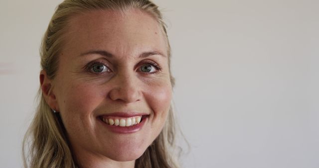 Smiling Caucasian Woman with Blond Hair Over Light Background - Download Free Stock Images Pikwizard.com