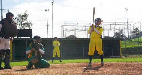 Baseball game action with batter and catcher on field