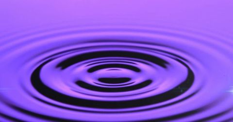 Purple ripples on water surface creating tranquil abstract patterns