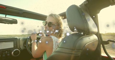 Smiling Woman Driving Convertible on Sunny Road Trip