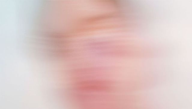 Warm blurred portrait suggestion with horizontal motion streaks abstract pastel gradient