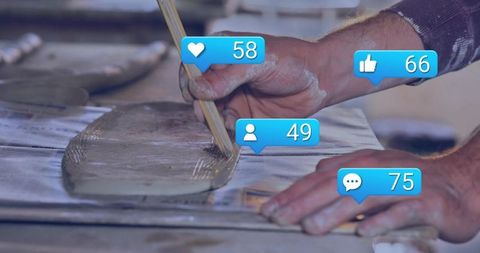 Hands spreading mortar showing digital engagement icons