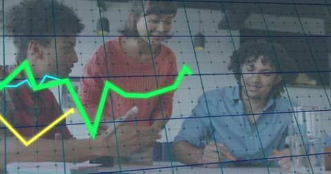 Young diverse team collaborating over analytics with green trend lines in modern office