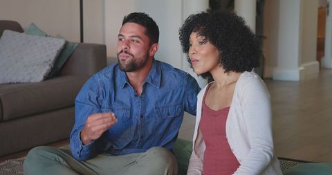 Couple Relaxing Watching TV In Cozy Living Room Setting