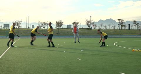 Field Hockey Players Practicing Drills on Artificial Turf