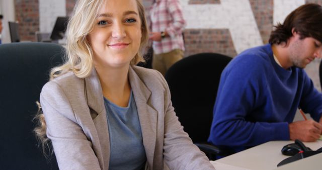 Young Professional Smiling in Office Environment - Download Free Stock Images Pikwizard.com