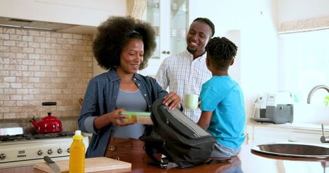 Happy Family Preparing Kids School Lunch Together