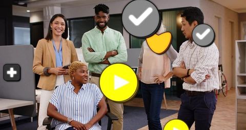 Diverse team collaborating in modern open-plan office, smiling, business casual