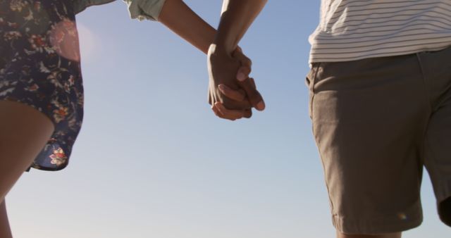 African american couple standing and holding hands on sunny beach with copy space - Download Free Stock Photos Pikwizard.com