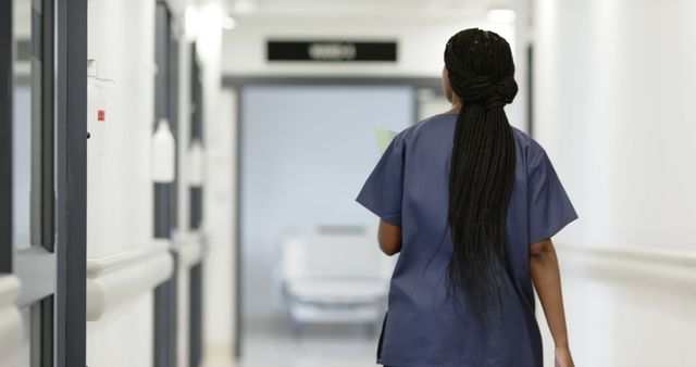 Female Nurse Walking Through Hospital Corridor - Download Free Stock Images Pikwizard.com