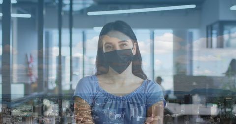 Businesswoman Wearing Facemask in Office with Cityscape Overlay - Download Free Stock Images Pikwizard.com
