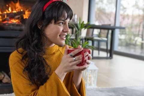 Cozy Relaxation by Fireplace with Woman in Warm Sweater