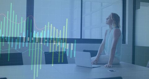 Businesswoman Analyzing Data with Overlaid Charts in Modern Office