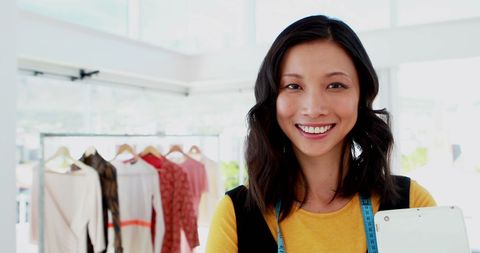 Cheerful Young Woman Holding Tablet in Stylish Workspace