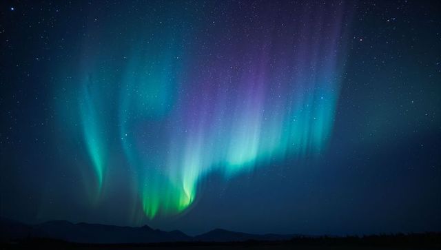 Majestic aurora borealis above northern tundra ridge