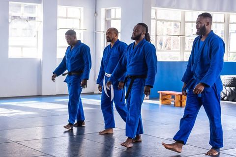 Karate Group in Blue Uniforms Training in Martial Arts Studio