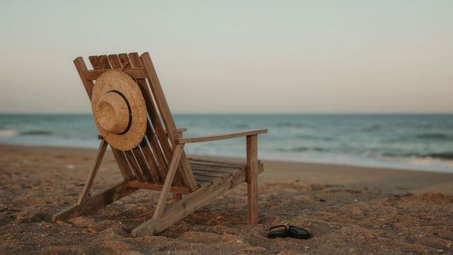 Beachside Serenity with Straw Hat on Wooden Chair at Sunset