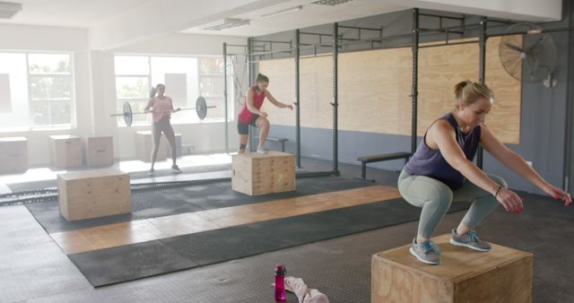 Women Performing Box Jumps and Weightlifting in CrossFit Gym - Download Free Stock Images Pikwizard.com