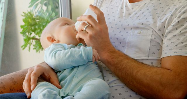 Father feeding baby with bottle at home - Download Free Stock Images Pikwizard.com