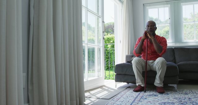 Senior Man Relaxing Indoors with Walking Cane - Download Free Stock Images Pikwizard.com