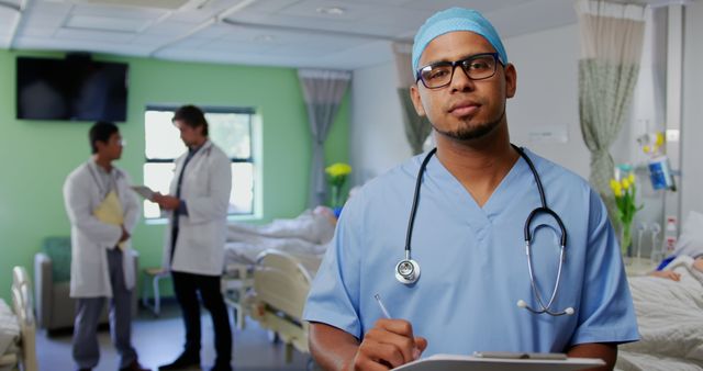 Confident Doctor with Clipboard in Modern Hospital Ward - Download Free Stock Images Pikwizard.com