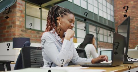 Focused businesswoman analyzing information on laptop screen at office desk