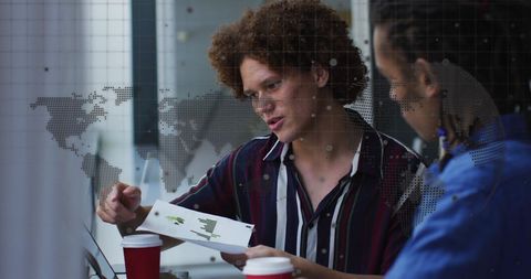 Diverse Business Team Analyzing Data in Office with Global Overlay