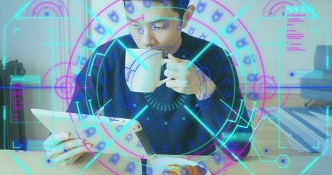 Asian man sipping coffee reading tablet at home holding mug with ar hud overlay