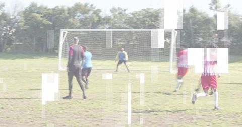 Youth soccer players charging toward goal with goalkeeper and digital glitch overlay