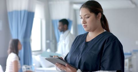 Female Doctor Using Tablet in Busy Hospital Ward - Download Free Stock Images Pikwizard.com