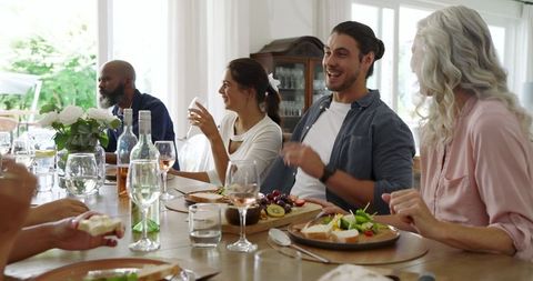 Friends Laughing Together at a Cozy Indoor Lunch Gathering