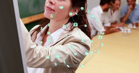 Businesswoman writing on whiteboard with network icon overlay