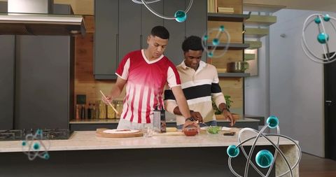 Young men preparing homemade pizza on modern kitchen island, friends cooking together