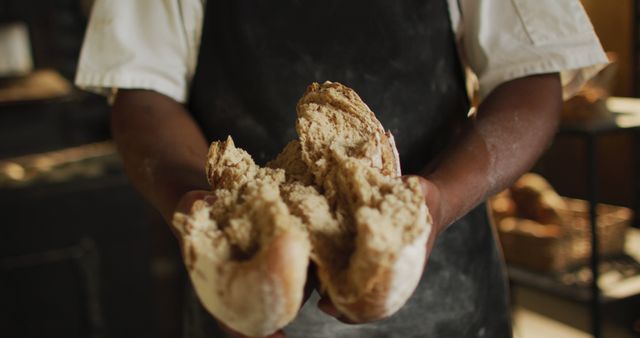 Baker holding freshly baked bread loaf in hands close up - Download Free Stock Images Pikwizard.com