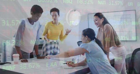 Diverse Female Coworkers Collaborating with Financial Data Overlay