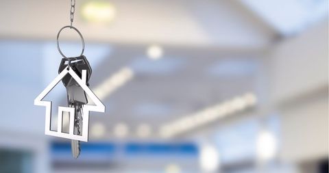 House-Shaped Keychain Hanging Indoors with Metal Keys