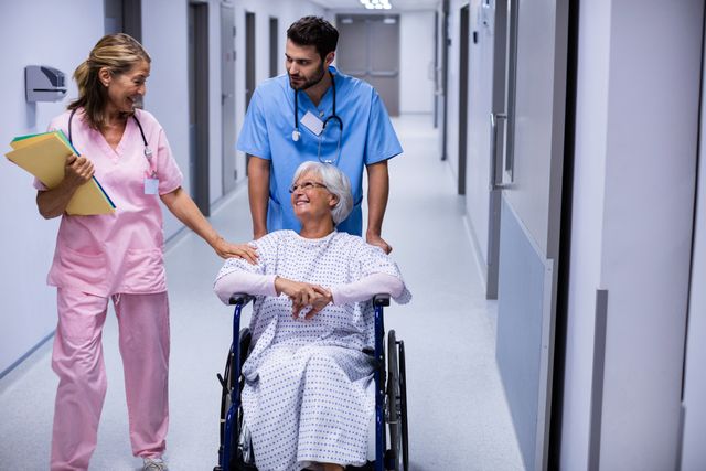 Medical professionals assisting a senior patient in a wheelchair, showcasing patient care and teamwork in a hospital setting. Ideal for healthcare advertisements, medical brochures, and articles on elderly care and hospital services.