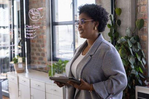 African American Businesswoman Presenting Data in Modern Office