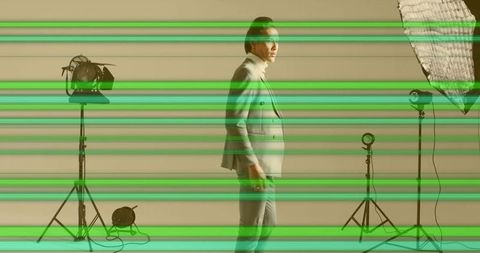 Elegant model in suit with studio lighting equipment