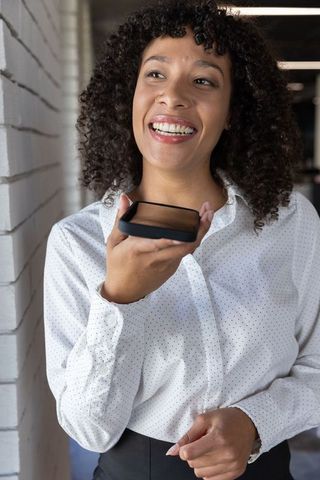 Professional Woman Communicating via Smartphone in Modern Office