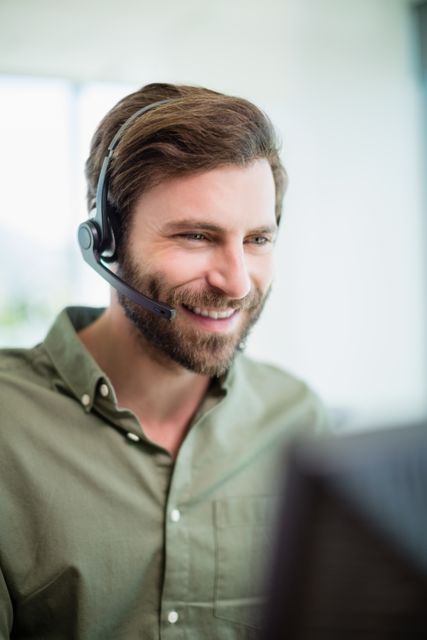 Smiling customer service executive working in call center