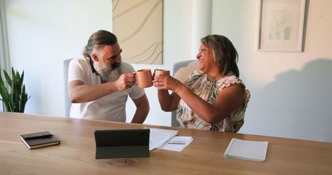 Senior Couple Relaxing at Home, Joyfully Sharing Coffee