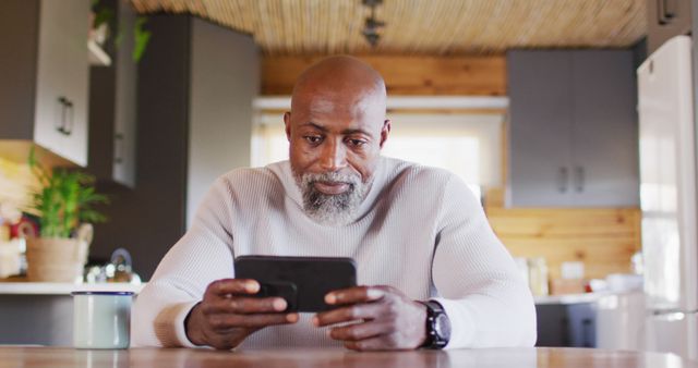 Mature Man in Cozy Modern Kitchen Using Smartphone - Download Free Stock Images Pikwizard.com