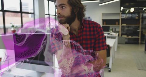 Developer Analyzing Purple Holographic Projection in Modern Office